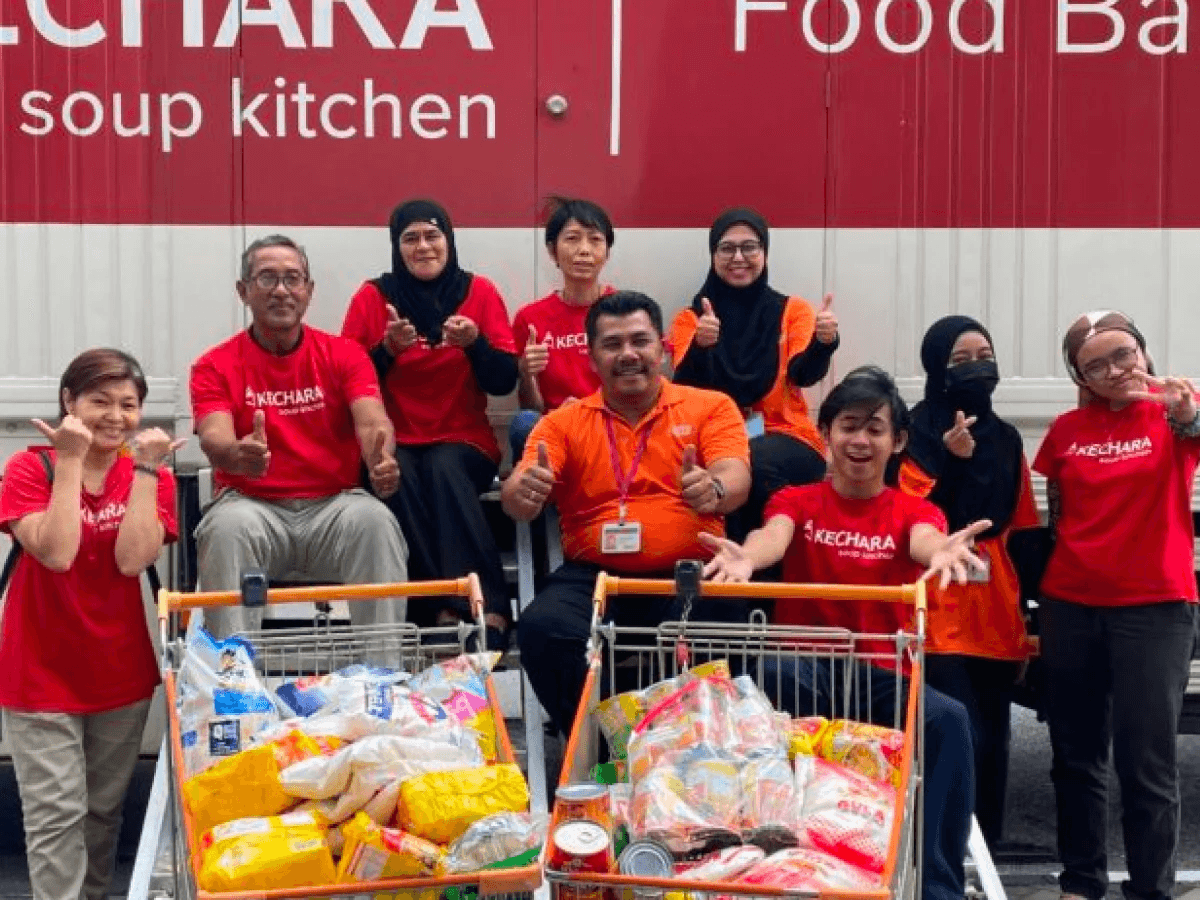 Volunteers from Penang distributing food packs to beneficiaries