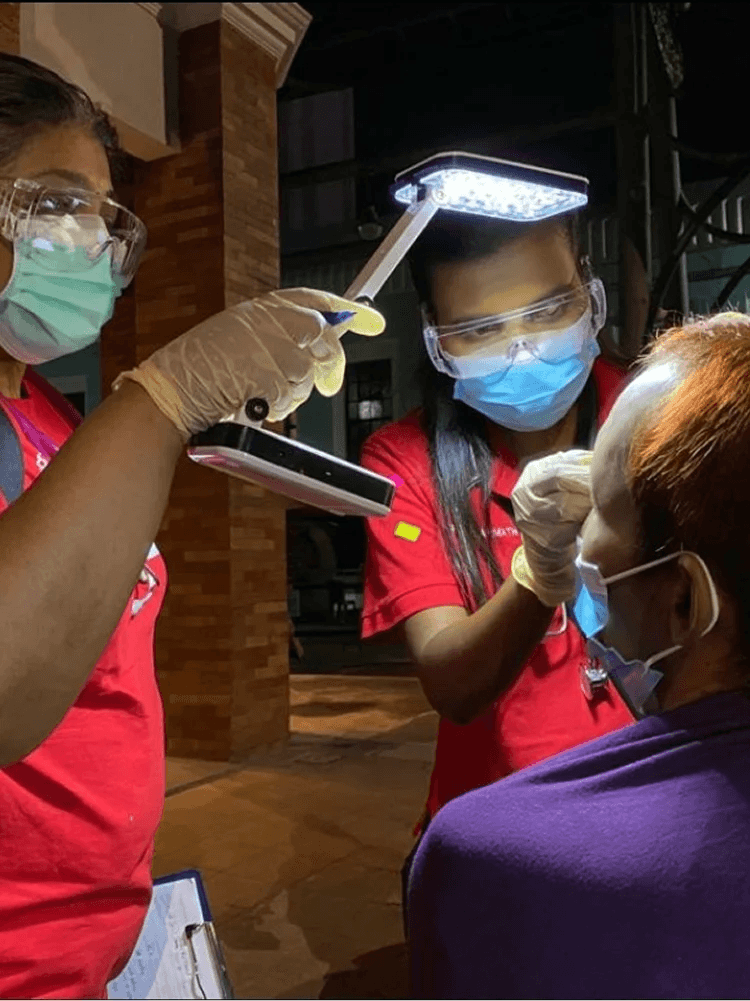 KSK Volunteer giving eye-check to a homeless person