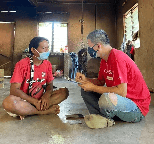 KSK volunteer chatting with beneficiary to learn more about their living condition
